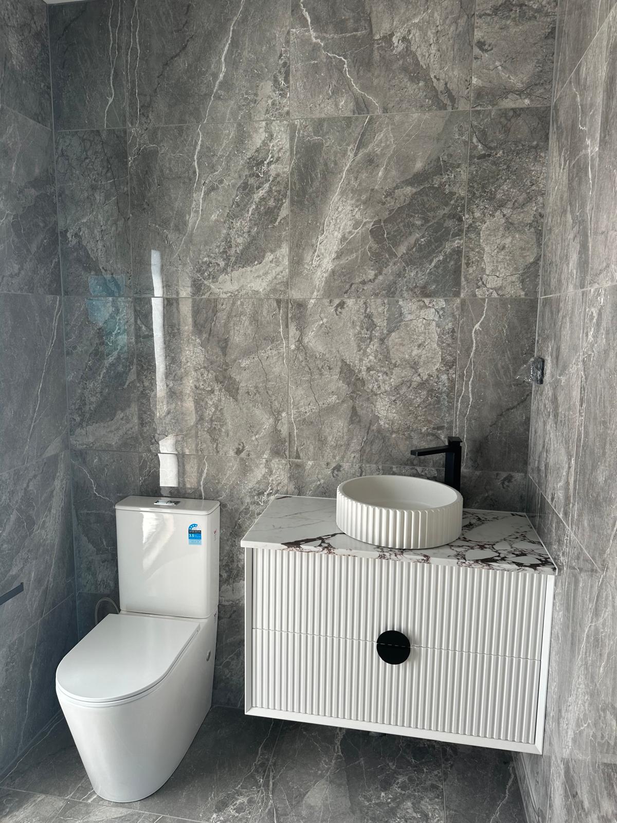 Modern powder room with fluted vanity and vessel sink